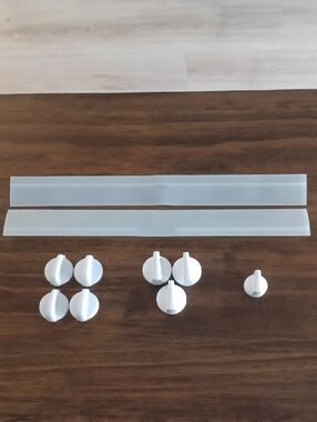 Bundle of GE oven cooktop range knobs, and two stove counter gap spill guards.